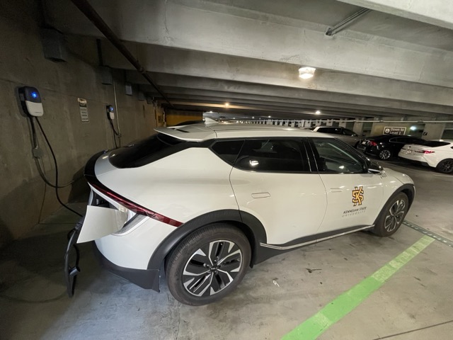 car in parking deck connected to electric charger