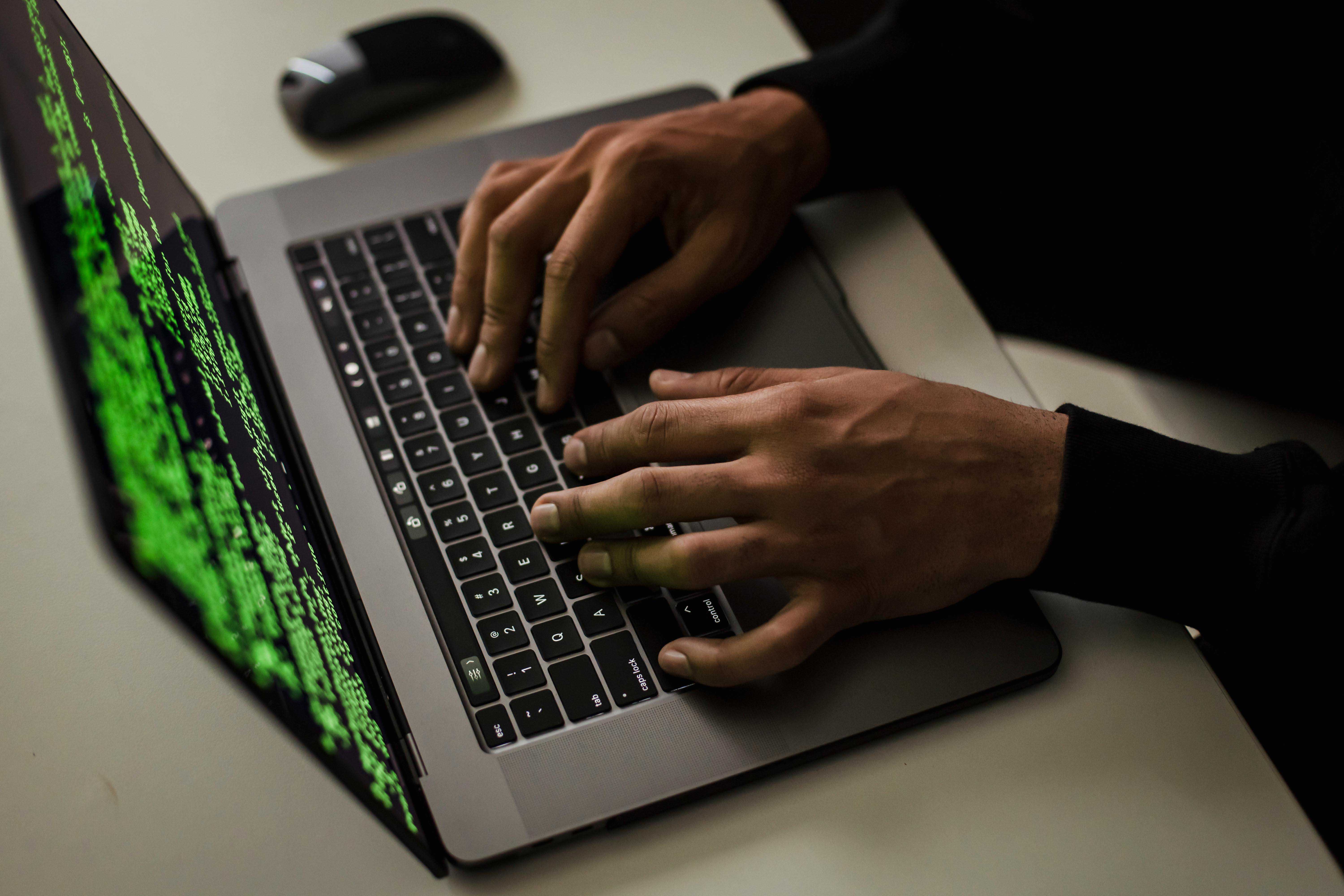 Close up on coders hand working on cybersecurity project